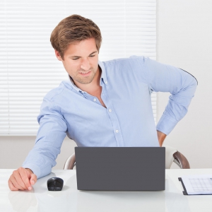 Business man Suffering from backache while working on Laptop
